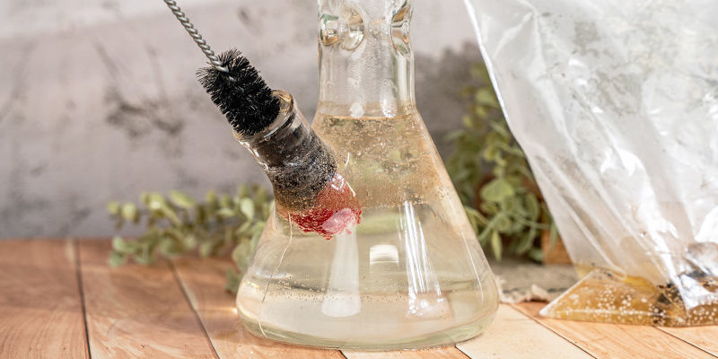 Ta därefter en borste och skrubba bort ingrodd smuts i och runt bongen samt på delarna Next, take a brush and scrub the built-up grime inside and around your bong and its parts